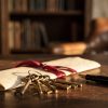 House keys resting on a folded legal document tied with a ribbon