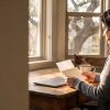 A woman at her kitchen table in a Central Texas home reads a letter about her stalled divorce case