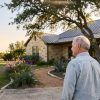 Retired couple outside their Texas Hill Country limestone home considering a transfer on death deed